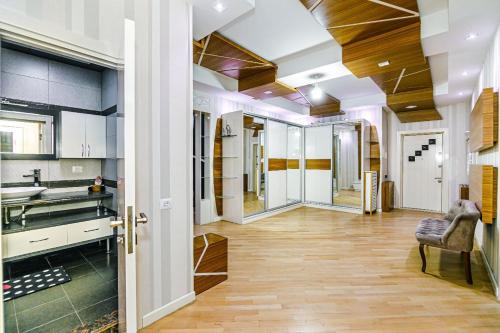 uma cozinha em plano aberto com pisos em madeira e paredes brancas em Konsul Apartment Nizami em Baku