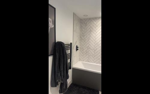 a bathroom with a bath tub and a sink at TMW stays in London
