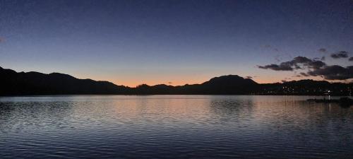 a sunset over a lake with mountains in the background at das stille Paradies in Ledenitzen