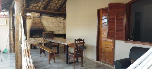 a dining room with a table and chairs at Casa das orquídeas in Santana do Riacho