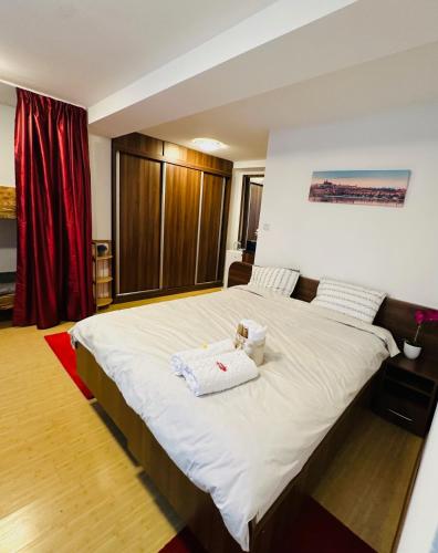 a bedroom with a large bed with two towels on it at Brasov Place in Braşov