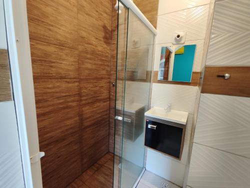 a bathroom with a shower and a sink at Pousada Sereia Tropical in Guarujá