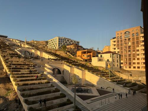 a large amphitheater in a city with buildings at TOUCH THE SKY Apartment in Yerevan