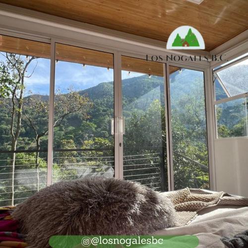 a bedroom with a view of a mountain through windows at Casa campestre Los Nogales BC in Manaure Balcón del Cesar