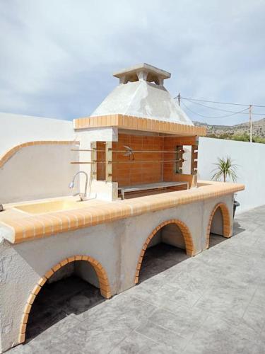 a small building with a sink on a roof at Traounou Bay villa in Afantou