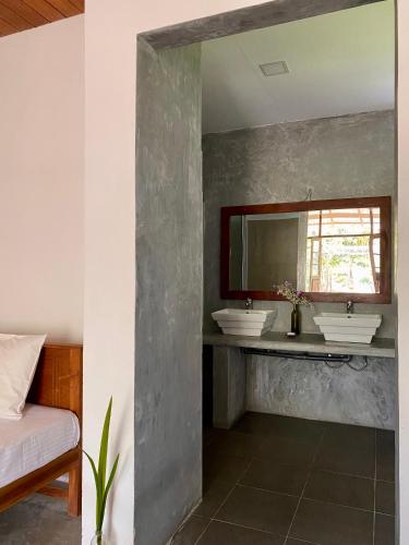 a bathroom with two sinks and a mirror at The Dale Mirissa in Mirissa