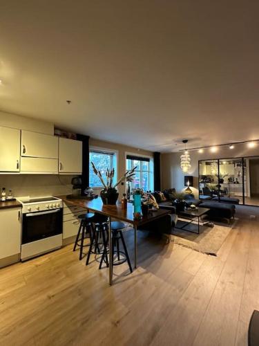 a kitchen and living room with a table and chairs at romslig leilighet til leie in Arendal