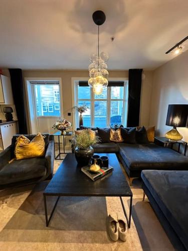 a living room with a couch and a table at romslig leilighet til leie in Arendal