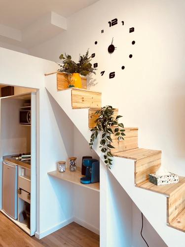a staircase in a house with a clock on the wall at D52 - das Businessapartment in Dresden
