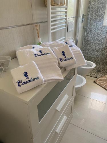 a bathroom with white towels sitting on a counter at Casalura in Polignano a Mare