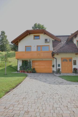 a house with a brick driveway in front of it at Studio apartment Velis in Radovljica