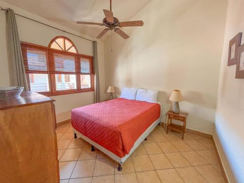 a bedroom with a bed and a ceiling fan at Ritz Empress in San Juan del Sur