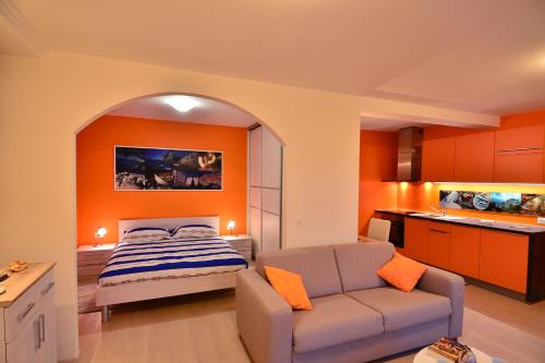 a bedroom with a bed and a couch in a room at Studio Apartment Colors of Dubrovnik in Dubrovnik