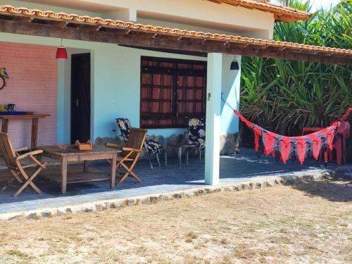 a patio of a house with a table and chairs at Pousada Estrela Feliz in Canavieiras