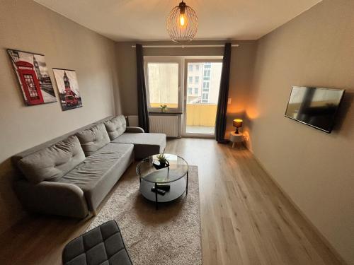 a living room with a couch and a table at Apartment Central 10H 75qm Wi-Fi free Parking in Dortmund