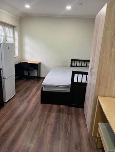 1 dormitorio con 1 cama y suelo de madera en Unique Studio Flat in City Center, en Leicester