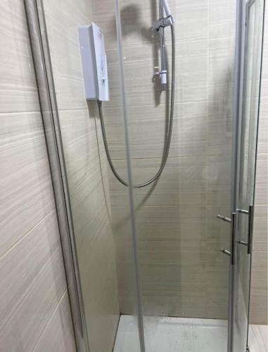 a shower with a glass door in a bathroom at Unique Studio Flat in City Center in Leicester