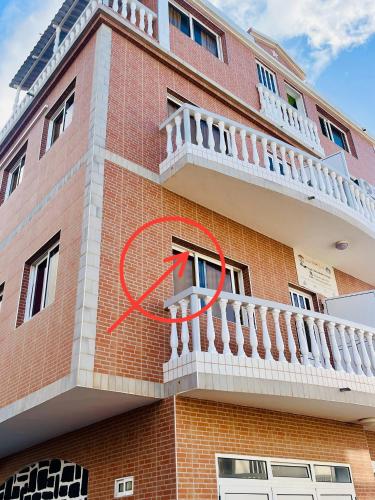 a building with a red peace sign on the side of it at Casa BB&Djassi - room T in Ponta do Sol