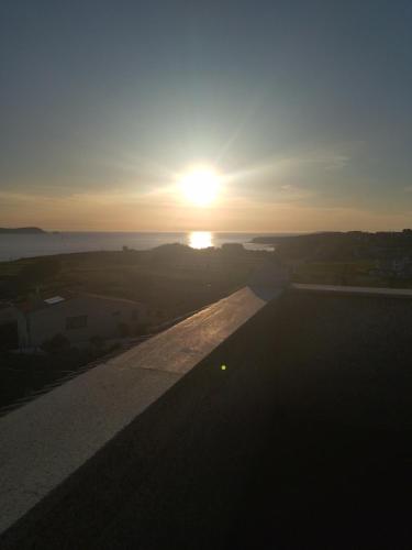 a view of the sunset from the roof of a building at Sandra in Pontevedra