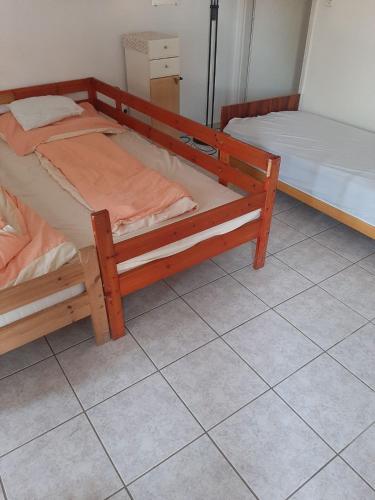 two bunk beds in a room with a tiled floor at Badacsony Hostel in Badacsonytomaj