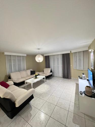 a large living room with couches and a tv at Stan na dan Jakov in Ljubuški