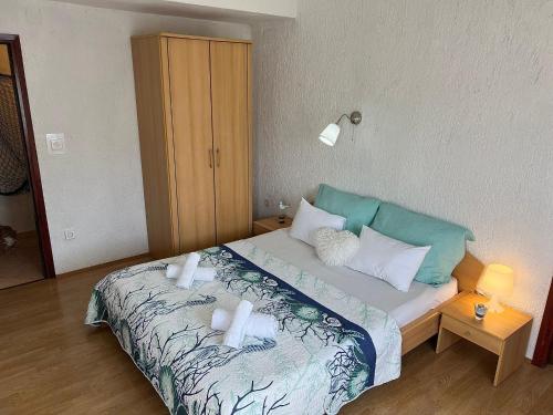 a bedroom with a bed with towels on it at Apartments Dora and Tonka Krk in Porat