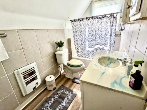 Baño pequeño con aseo y lavamanos en Cute 3BR house with Pool Table - Bookings by rooms!, en Charleston
