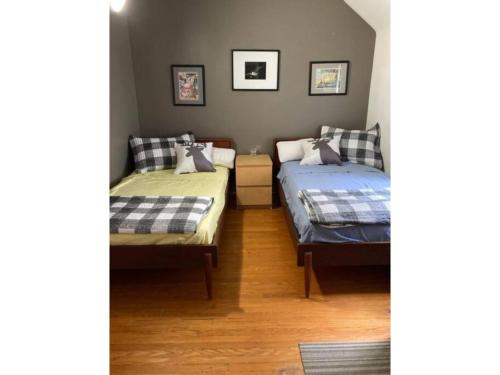 a bedroom with two beds and a couch at Lovely Leslieville, exploring nature in the city in Toronto