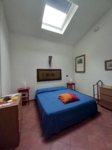 a bedroom with a blue bed and a skylight at "La Casita", 2 Floors Apartment, Private Parking 1 car OR 2 Bikes, Air-Cond and Terrace in Livorno