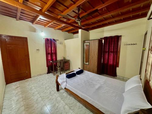 sypialnia z dużym łóżkiem w pokoju w obiekcie Acharya Compound w mieście Udupi