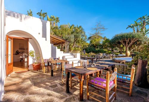 a group of tables and chairs on a patio at Villa Ravino Secret Retreat in Ischia