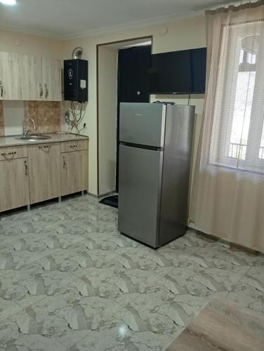 a kitchen with a refrigerator in the middle of a room at Borjomi forest in Borjomi