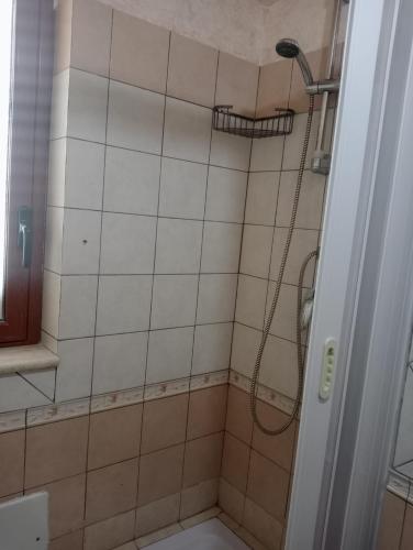 a bathroom with a shower with a shower head at M'arriposu in Realmonte