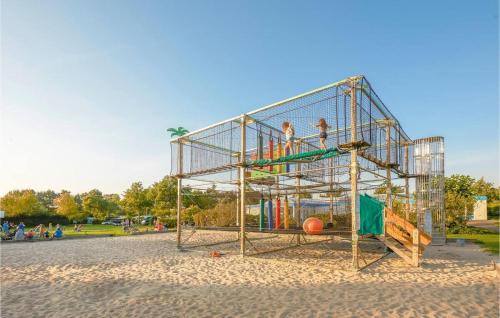 two people playing in a cage at a playground at Bondi Beach in Renesse