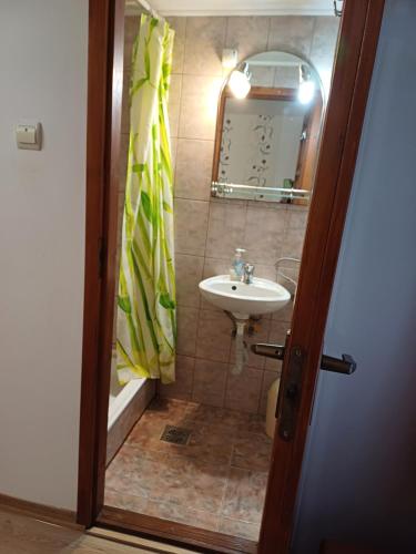 a bathroom with a sink and a mirror at Casa ,,Kiss-lak,, in Praid