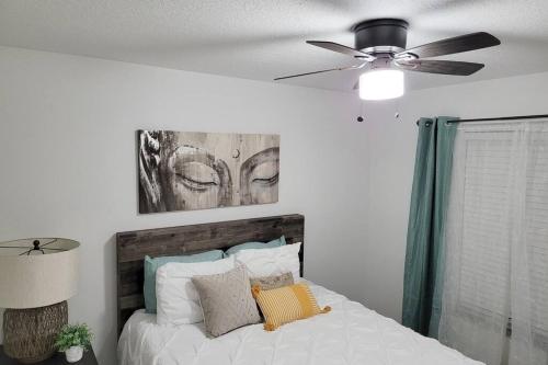 a bedroom with a bed with a ceiling fan at Upscale Ybor House with Outdoor Living Space in Tampa