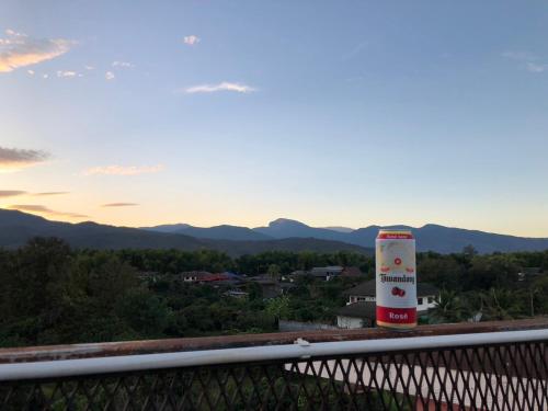 a view of the mountains from the balcony of a house at โรงแรมแสนดีเพลส เมาเท่นวิว จอมทอง in Chom Thong