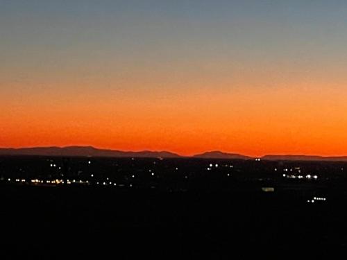 an orange sunset with mountains in the background at Rivad’Elsa in Baone