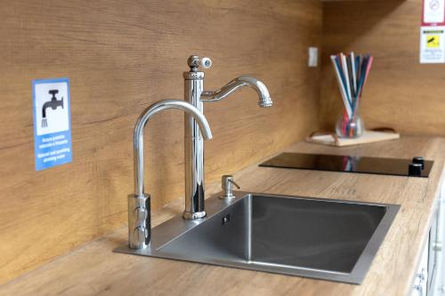 a kitchen sink with a faucet on a counter at Colosseo House in Rome