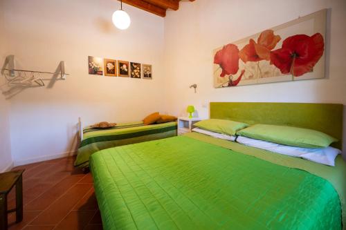 a bedroom with two beds with green sheets at La Virgy per Noto with share swimming pool with woderful seaview in Avola