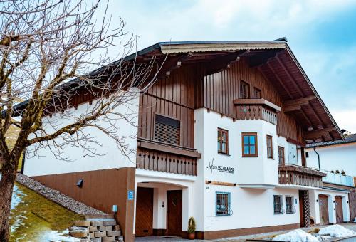 a large white building with a wooden roof at Haus Schlager "dasFerienhaus" in Annaberg im Lammertal