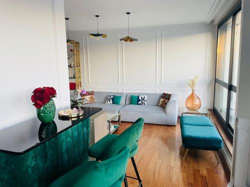 - un salon avec des fauteuils verts et un canapé dans l'établissement Duplex de 160 m2 vue sur Seine, à Boulogne-Billancourt