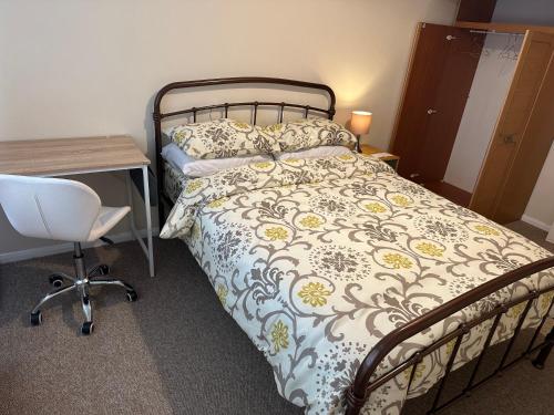 a bedroom with a bed and a desk and a chair at 10 Edney Court in Earley