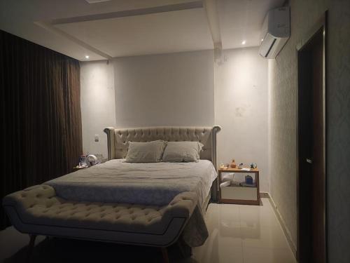 a bedroom with a large bed with a white bedspread at Casa Amsterdam in Lauro de Freitas