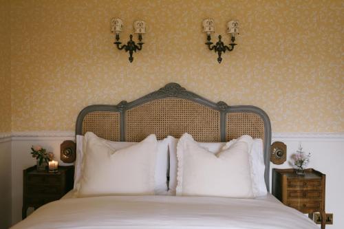 a bedroom with a bed with white pillows at Mossie's in Adrigole