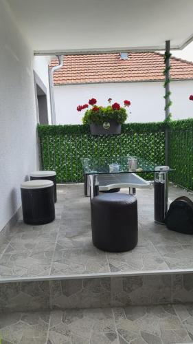 a patio with a table and two stools at Villa Ruža in Golubac