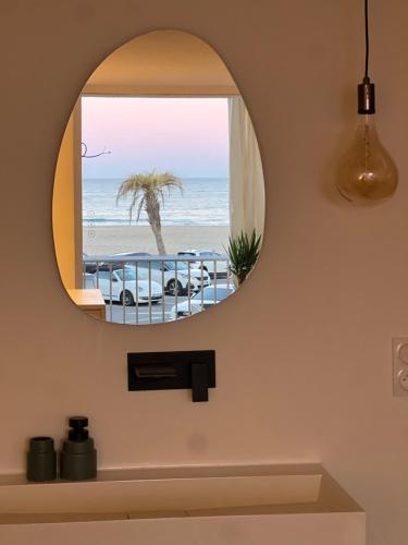 a bathroom mirror with a view of the beach at Superbe, face à la mer, balneo, rétroprojecteur in Canet-en-Roussillon