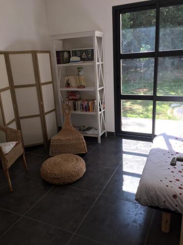 a room with a bedroom with a bed and a book shelf at Villa Cabries in Cabriès