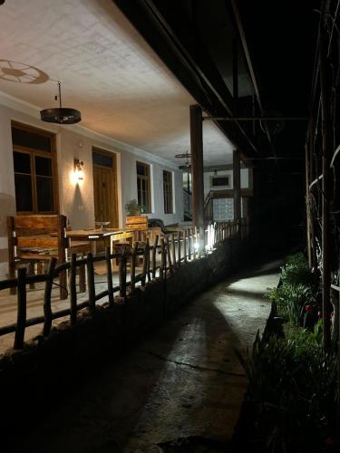an empty patio at night with a table and chairs at HamEl Guest House in Odzun