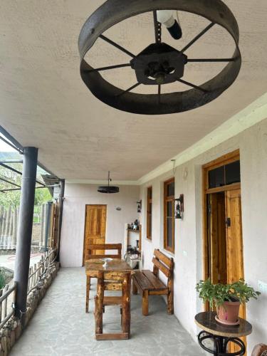 a chandelier hanging over a porch with a table and chairs at HamEl Guest House in Odzun